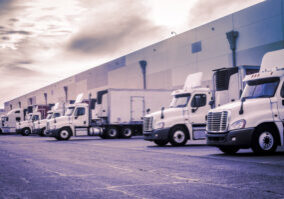 Trucks loading unloading at warehouse shipping logistics transport concept image Trucks loading unloading at warehouse shipping logistics transport concept image
